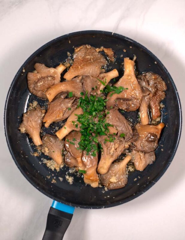 fresh herbs are added to the pan.