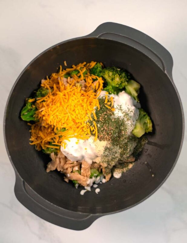 A large mixing bowl showing the pre-cooked vegan chicken and broccoli with the other sauce ingredients.