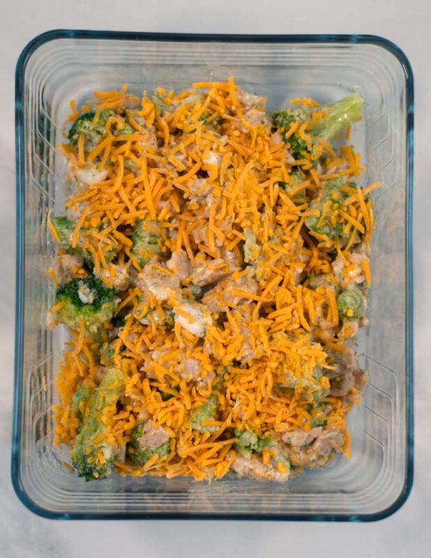 Top view of a baking dish with Ranch Chicken Casserole granished with vegan cheese.