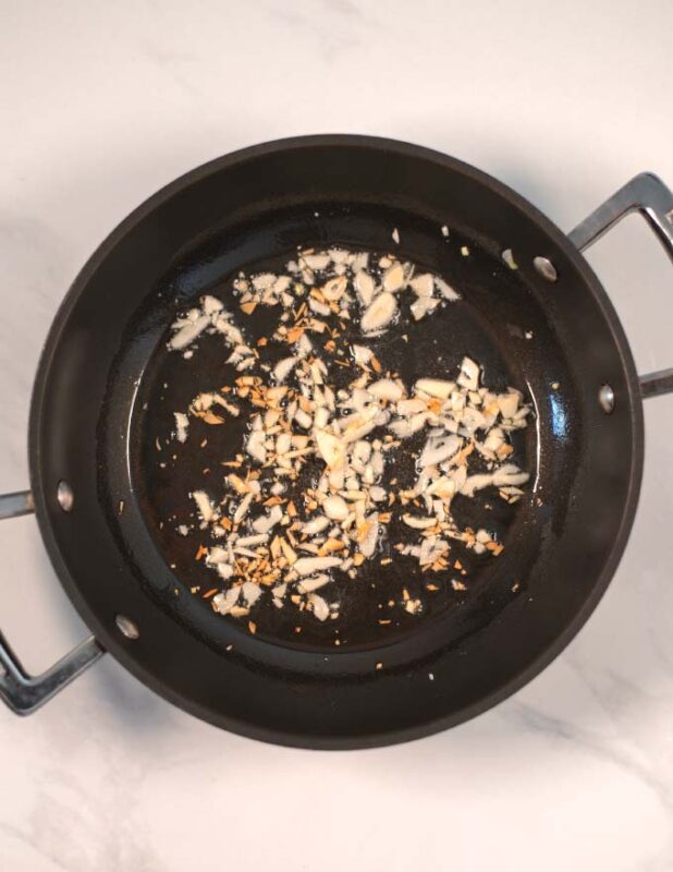 Minced garlic is toasted in olive oil.