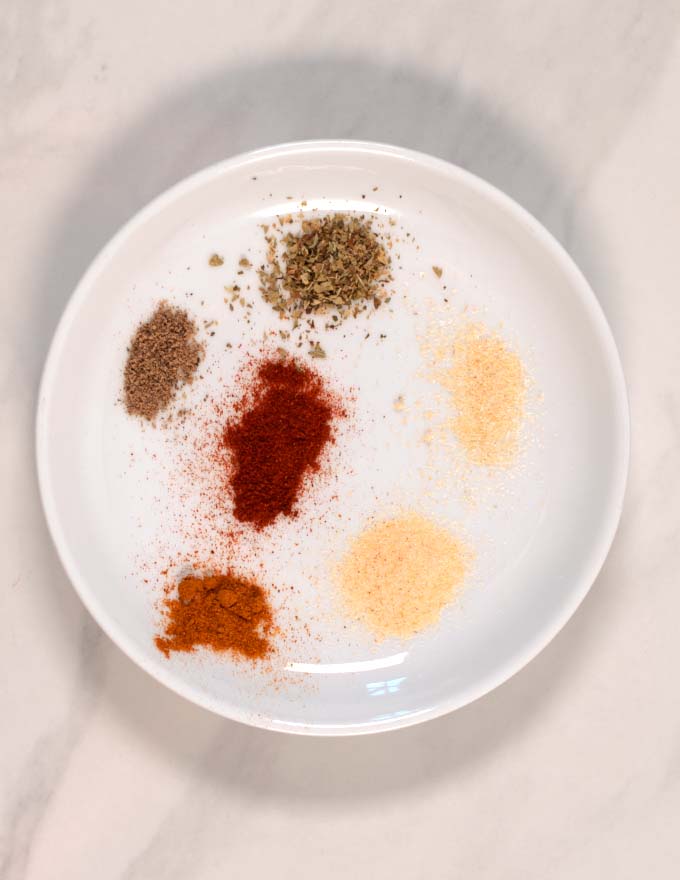 Ingredients of the Spaghetti Seasoning on a white plate.