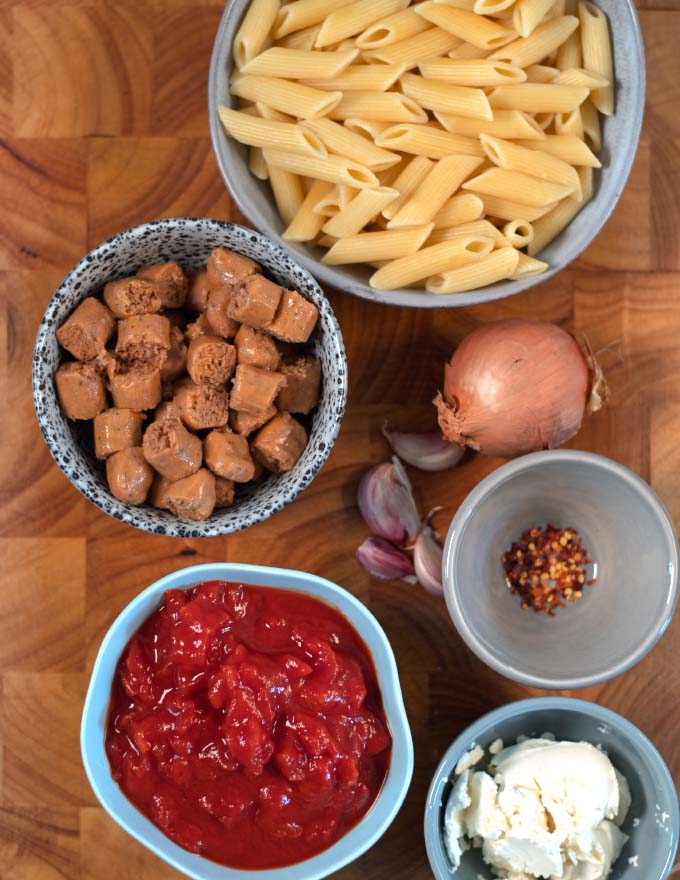 Ingredients needed to make Hot Dog Pasta on a board.