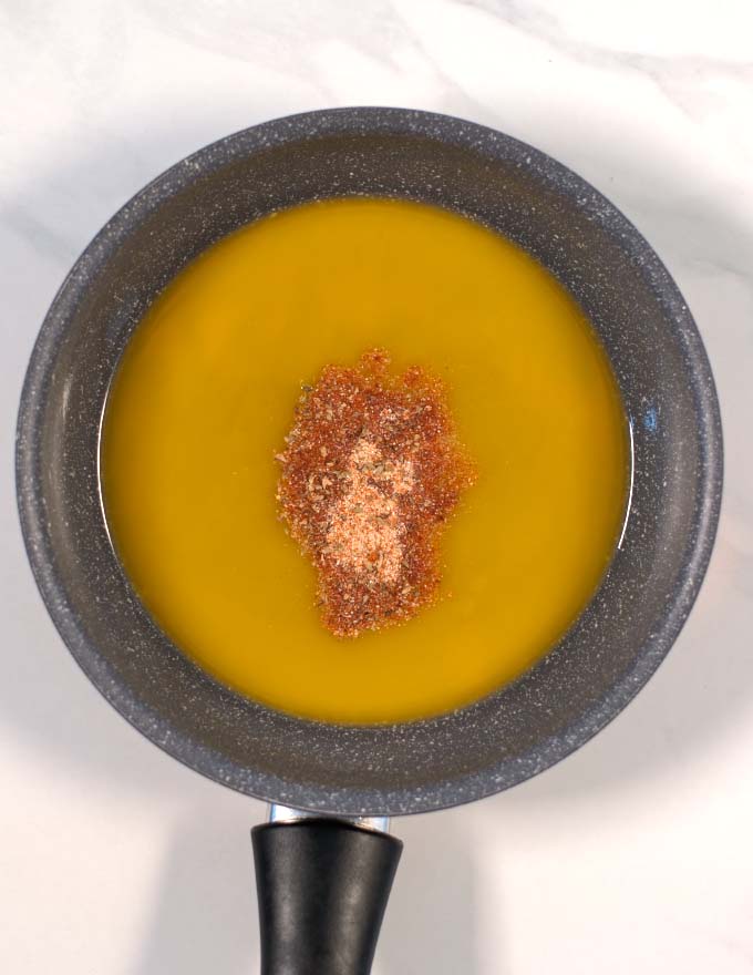 Butter is melted and homemade Cajun seasoning is given to the pan.