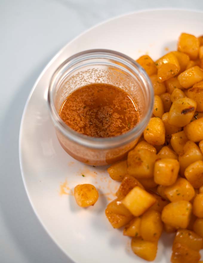 Closeup of Cajun Garlic Butter Sauce in a glass jar.
