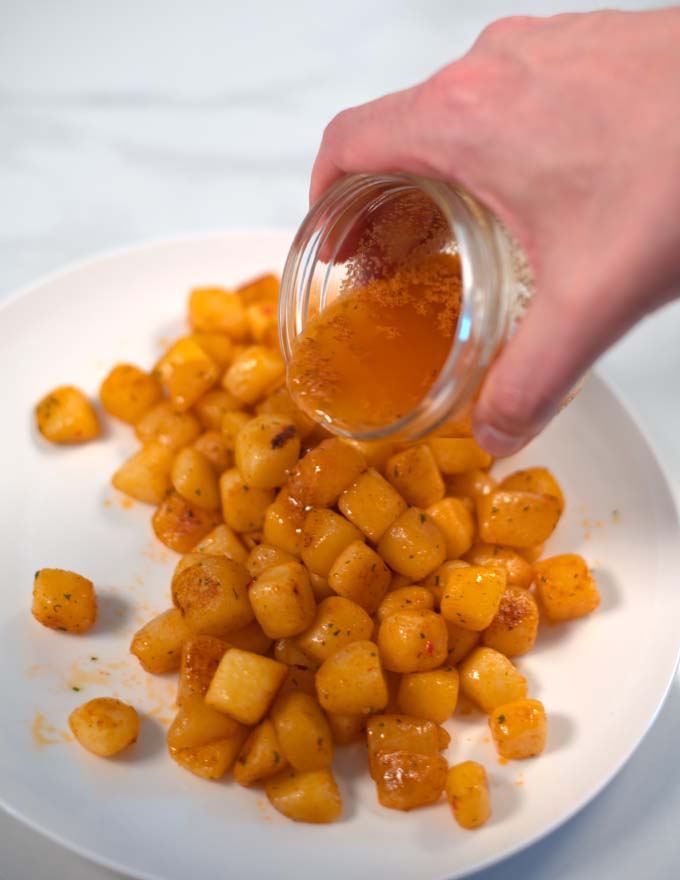 Cajun Garlic Butter Sauce is poured over potatoes.