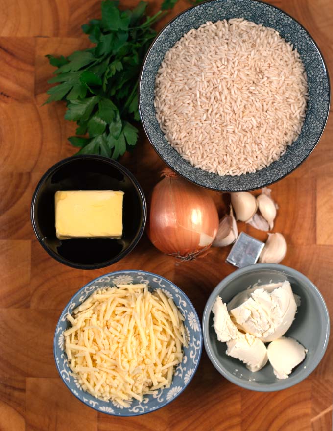 Ingredients needed for making Cheese Rice are collected on a board.