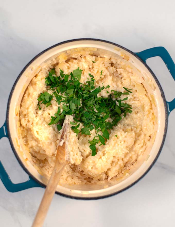 Fresh parsley is given to the pot with the Cheese Rice.