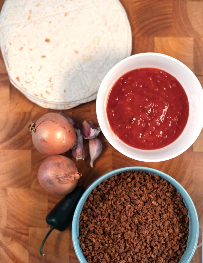 Ingredients needed to make Flautas are collected on a board.