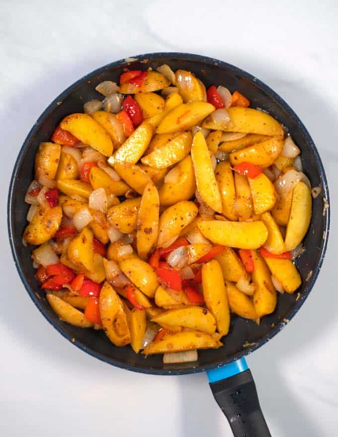 Ready Potatoes with Peppers and Onions in a pan.