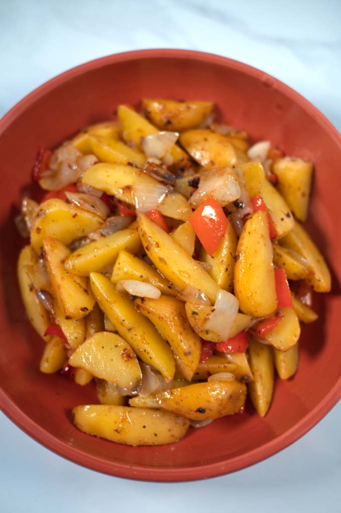 Closeup on a serving of Potatoes with Peppers and Onions.