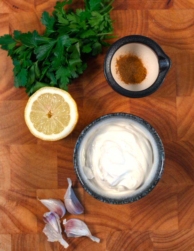 Ingredients needed to make Samosa Sauce are collected on a board.
