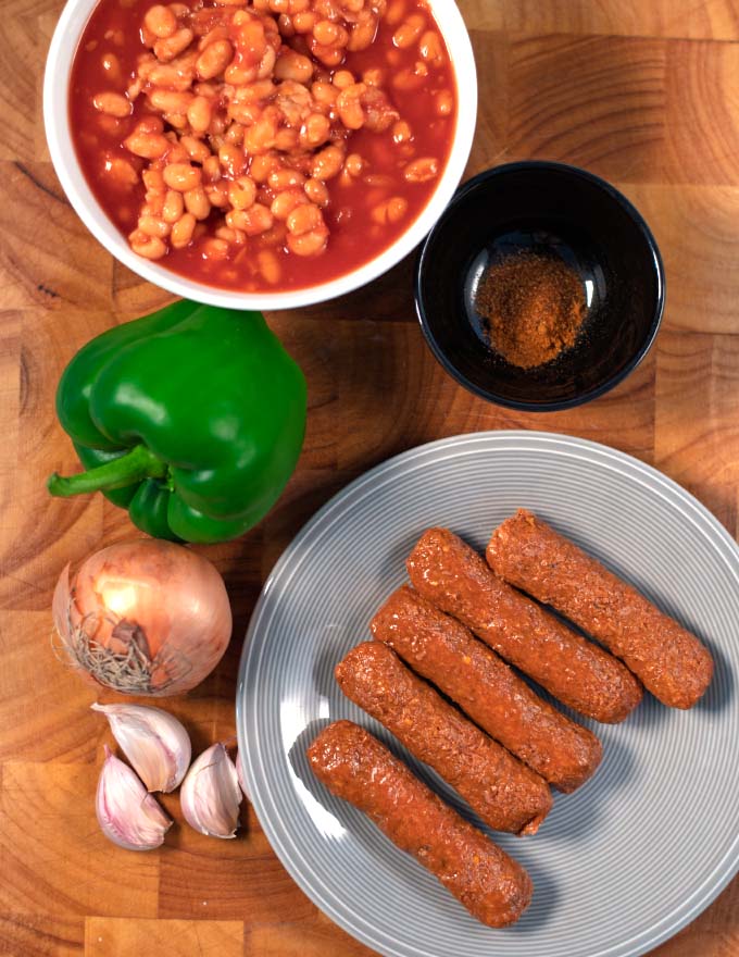Ingredients needed to make Sausage Chili are collected on a board.