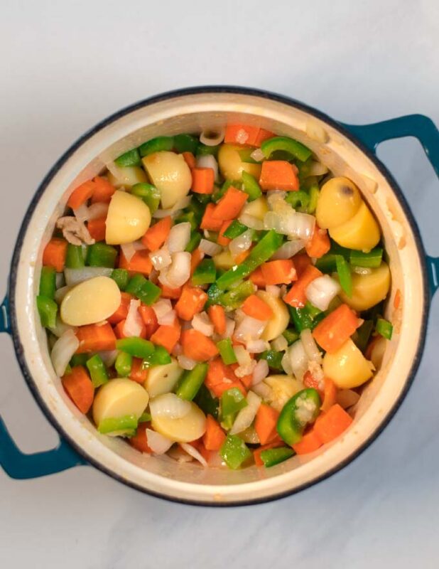 Aromatics and vegetables are sauteed in the same pot.