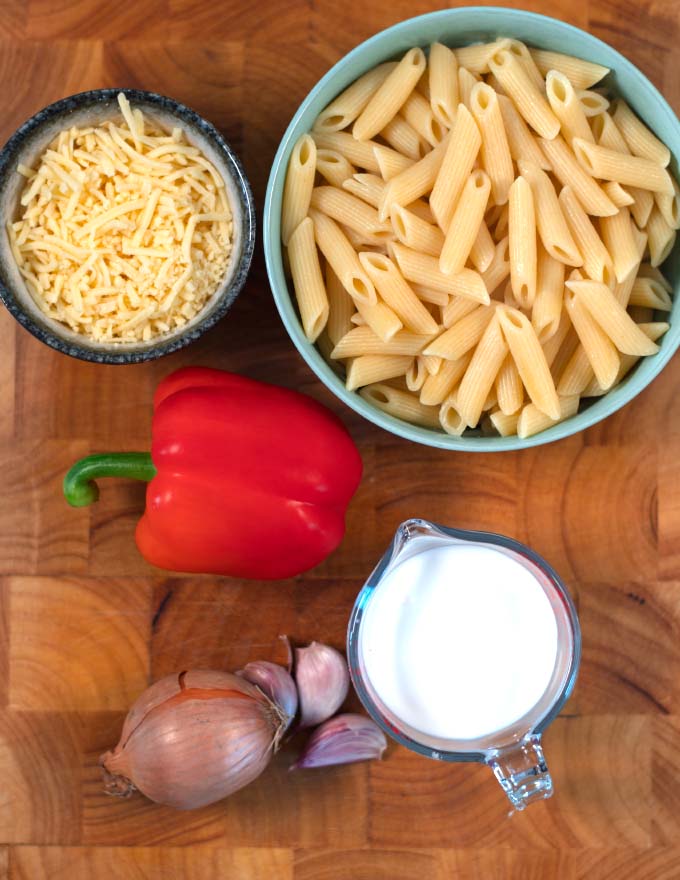 Ingredients needed to make Haitian Macaroni and Cheese collected on a board.