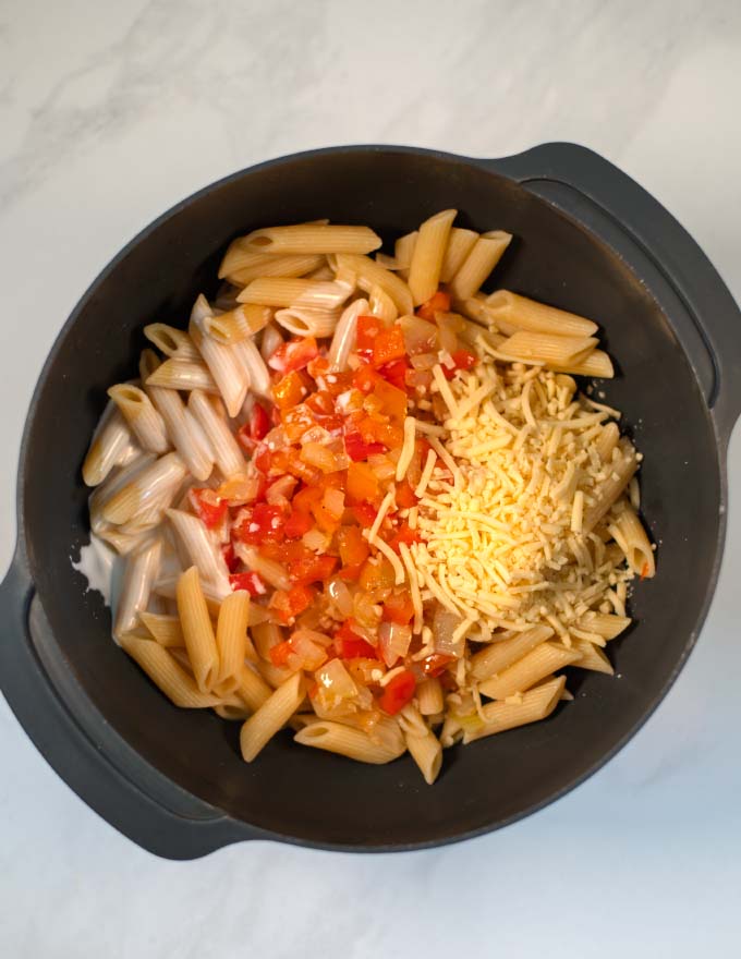 Precooked pasta is mixed with creamy sauce and vegetables.