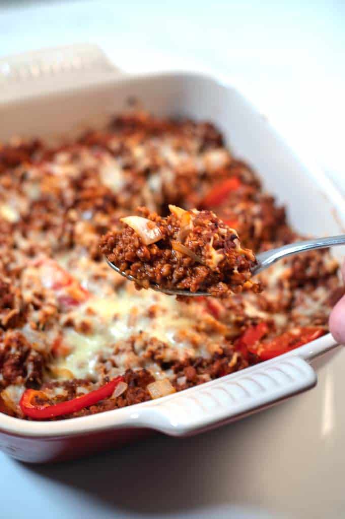 A spponful of Keto Sloppy Joe Casserole is lifted from the baking dish.