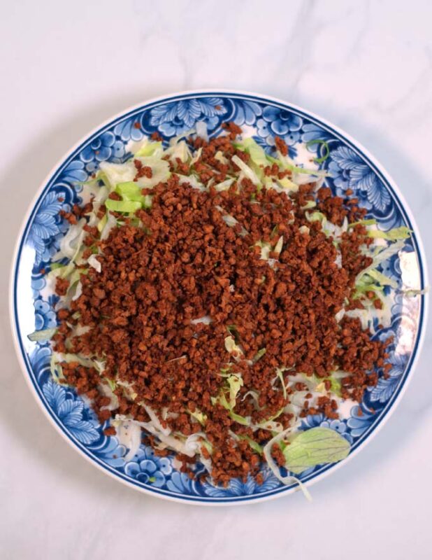 Taco Meat is given over iceberg lettuce.