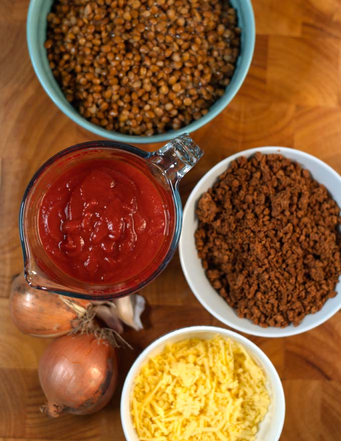 Ingredients needed to make Lentil Casserole are collected on a board.