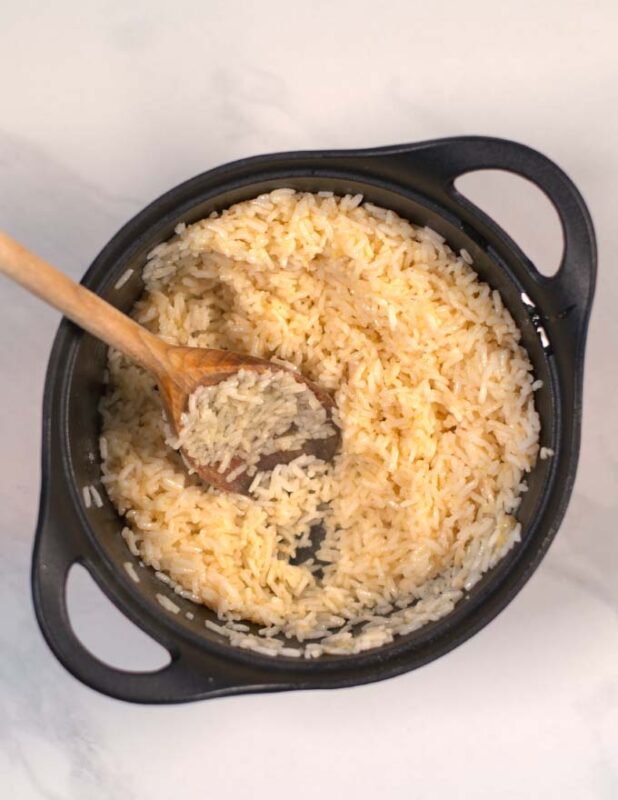 Rice is added to the pot with sauteed garlic.