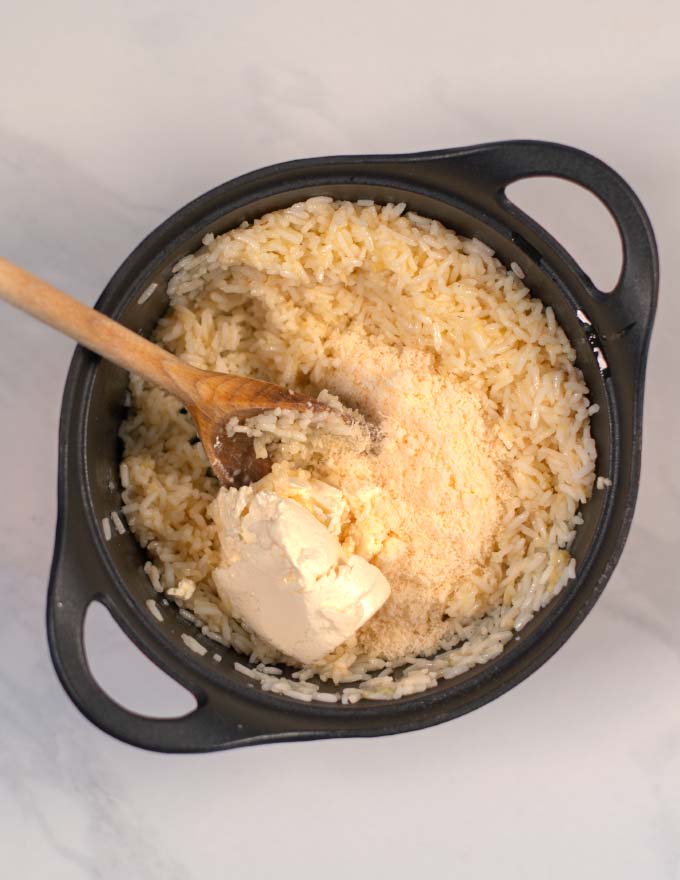 Vegan parmesan and sour cream are added to the pot.