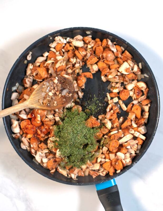 Chopped mushrooms are added to the pan with the sausage mixture.