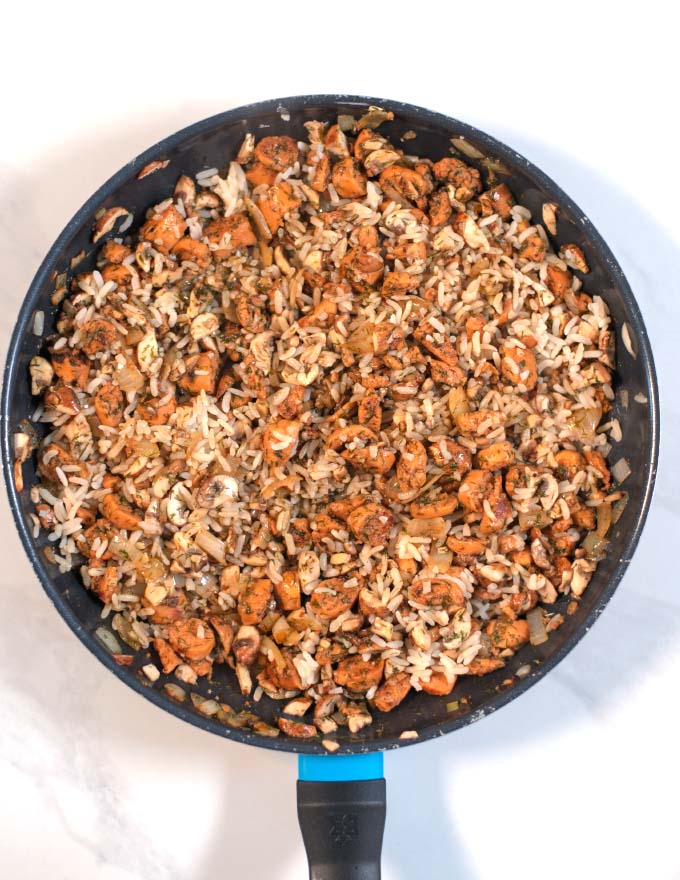 Mixed sausage-mushroom-rice stuffing in a pan.