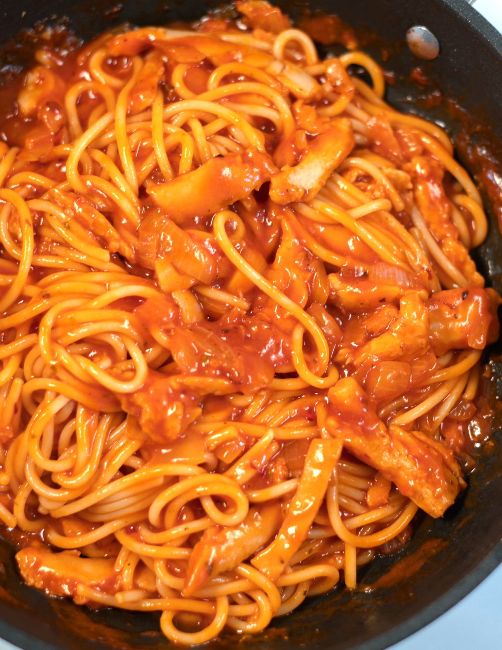 Closeup of spaghetti served with Chicken Marinara Sauce.