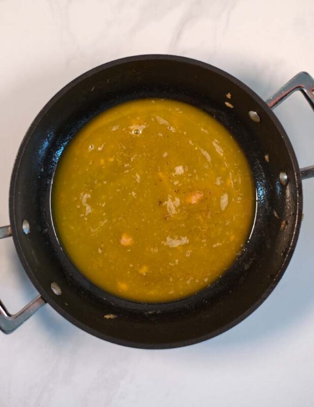 Vegan butter and lemon juice are combined in a saucpan.