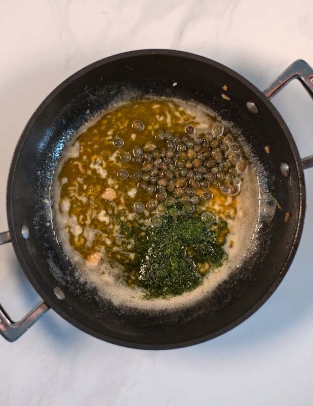 Capers and dill are given to the pan.
