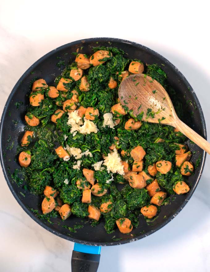 Spinach and garlic and added to the pan with the sausage bits.