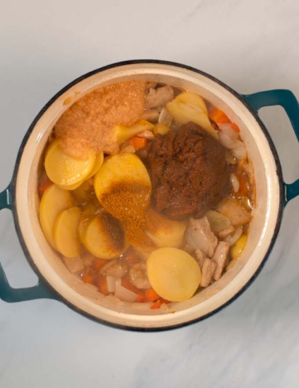 Spices, lemon grass paste and curry paste are given to the pot.