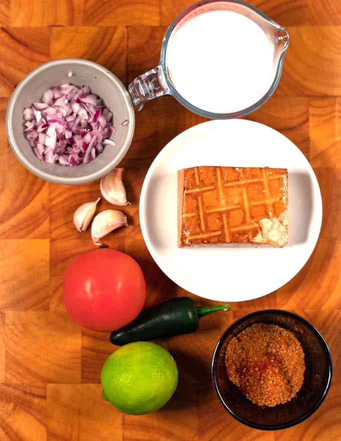 Ingredients needed to make Coconut Lime Tofu on a prep board.