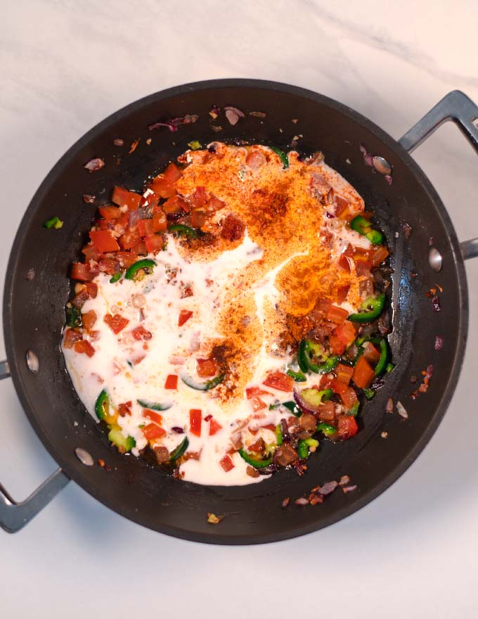 Coconut milk and lime juice are mixed into the pan.