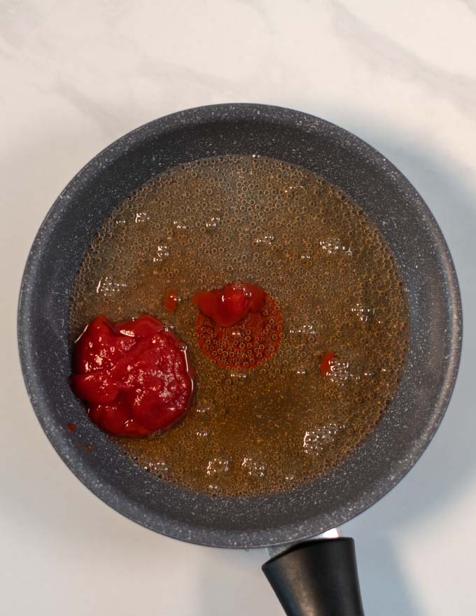 Tomato Paste and white wine vingear in a pan.