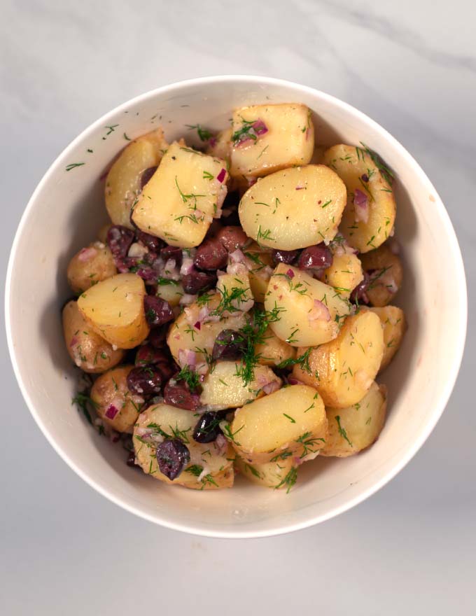 Greek Lemon Potato Salad in a white bowl.