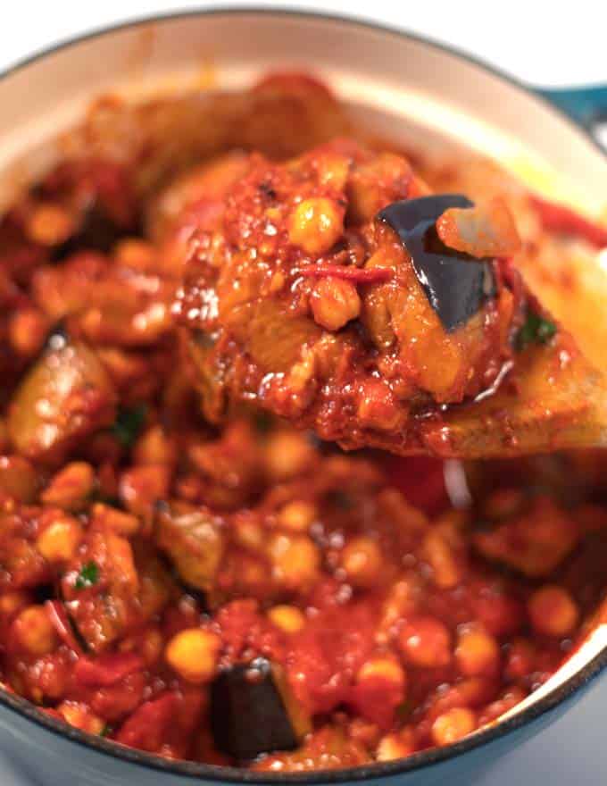 A wooden spoon lifts Lebanese Moussaka from the pot.