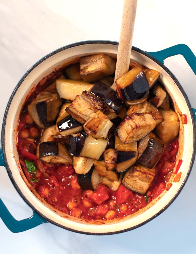 Roasted eggplants are given into the pot with the stew.