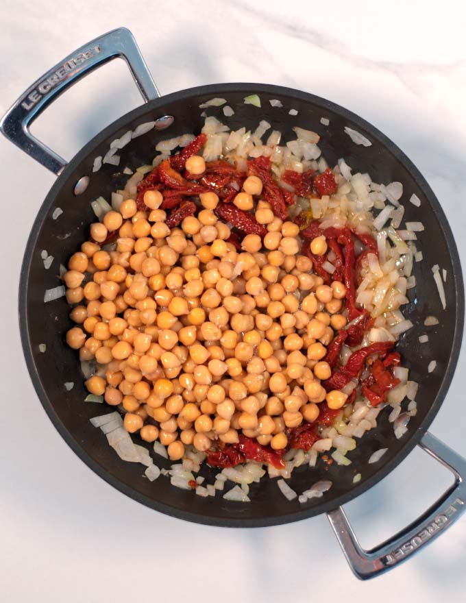 Sauteed onions, garlic are mixed with sun-dried tomatoes and chickpeas.