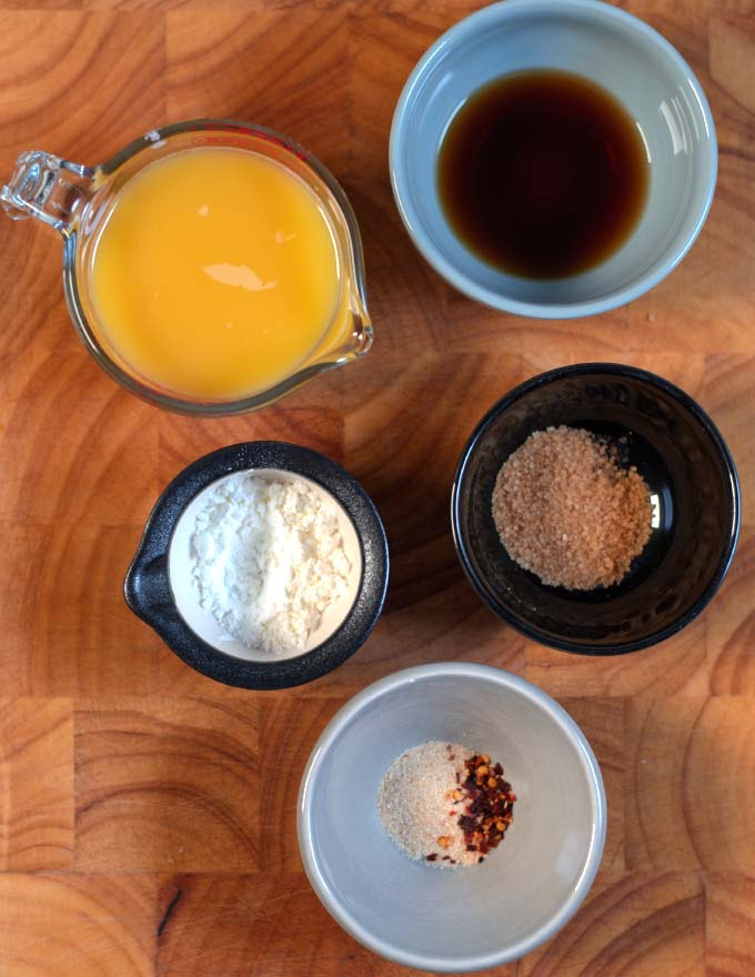 Ingredients needed to make Chinese Orange Sauce on a board.