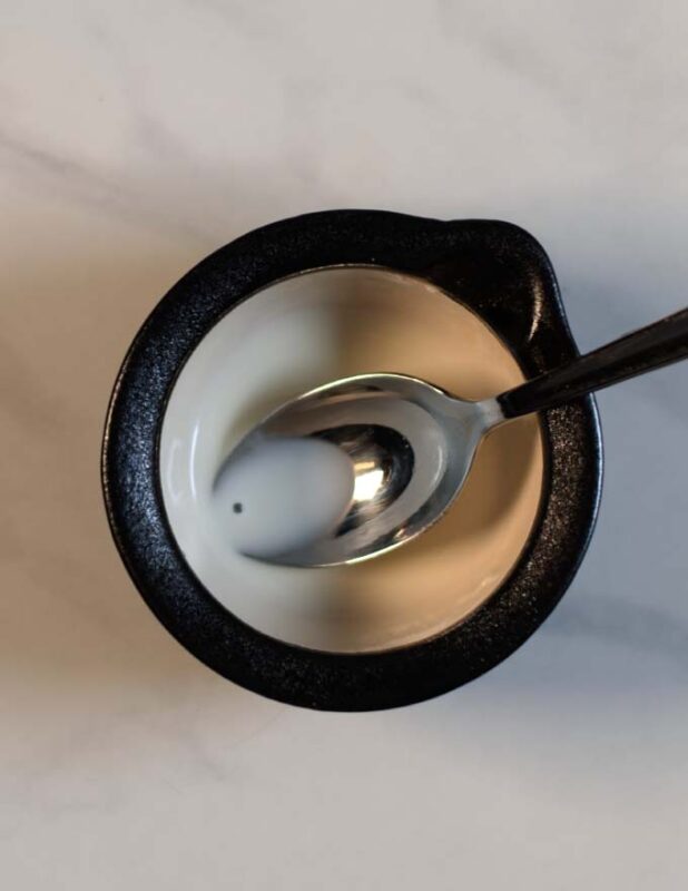 Corn starch slurry in a small bowl.