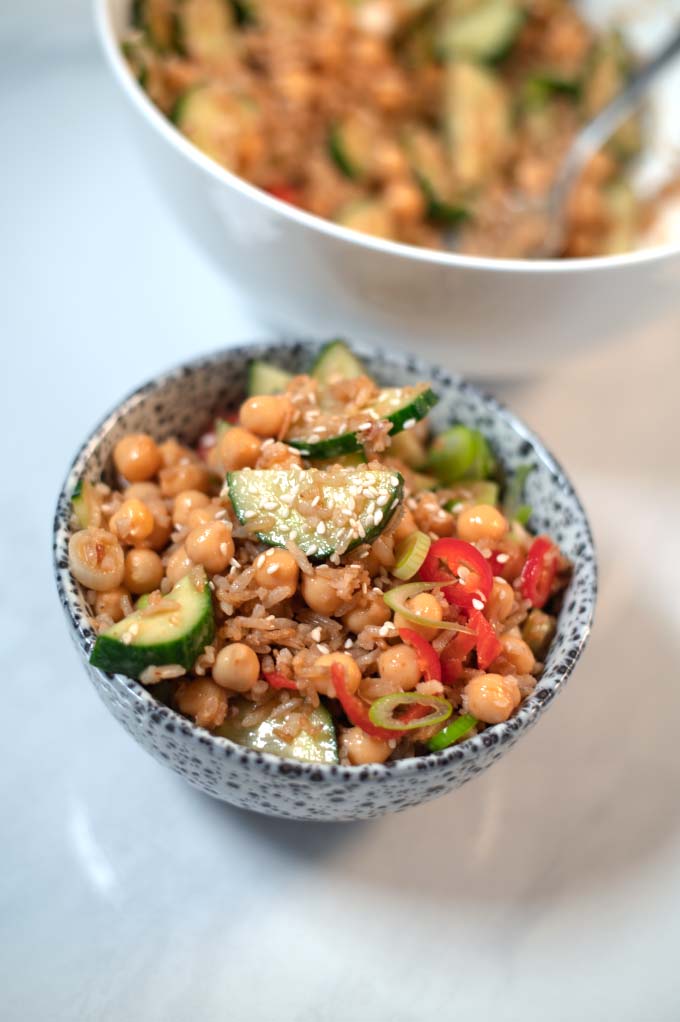 Closeup on a serving of Crispy Rice Salad garnished with sesame seeds.