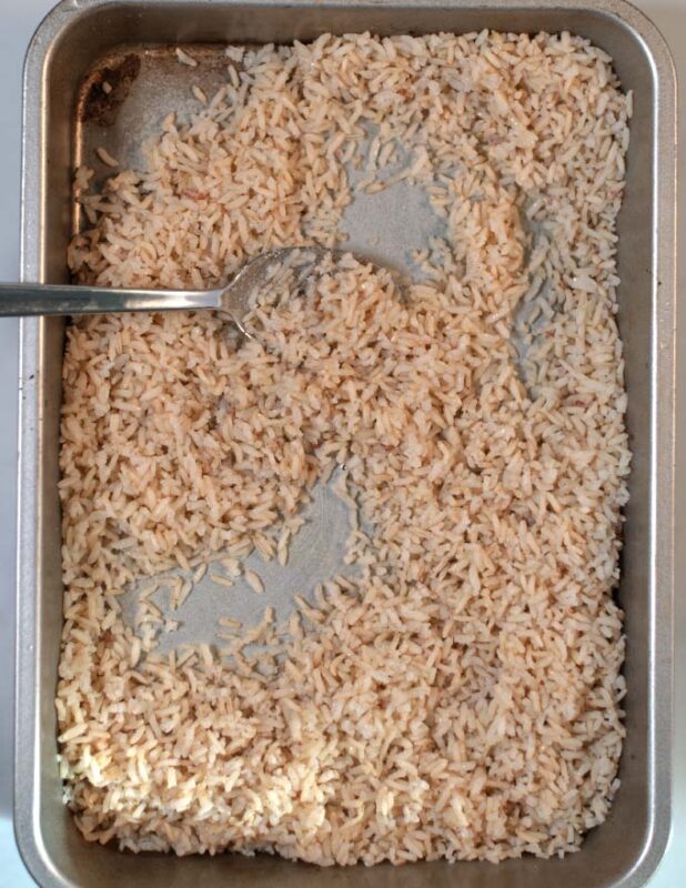 Precooked, cooled rice is tossed in oil and given to a baking dish.