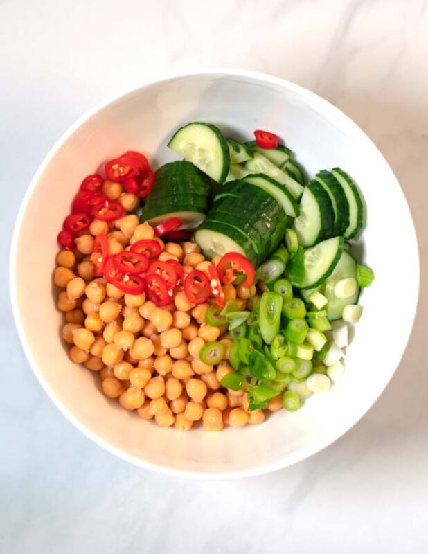 Salad ingredients in a white mixing bowl.