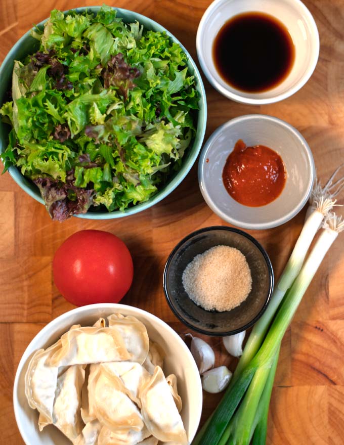 Ingredients needed to make Dumpling Salad collected on a cutting boat.
