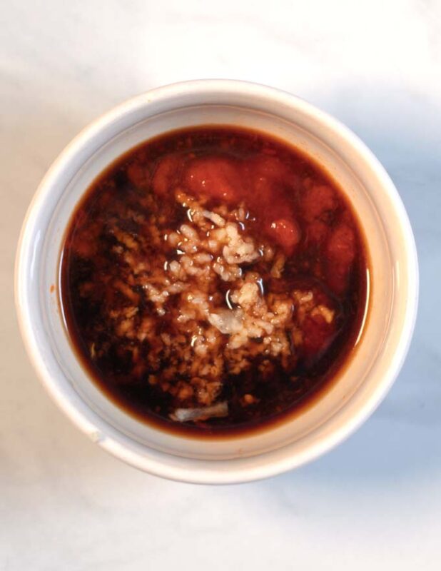 Ingredients for the sambal sauce in a small mixing bowl.