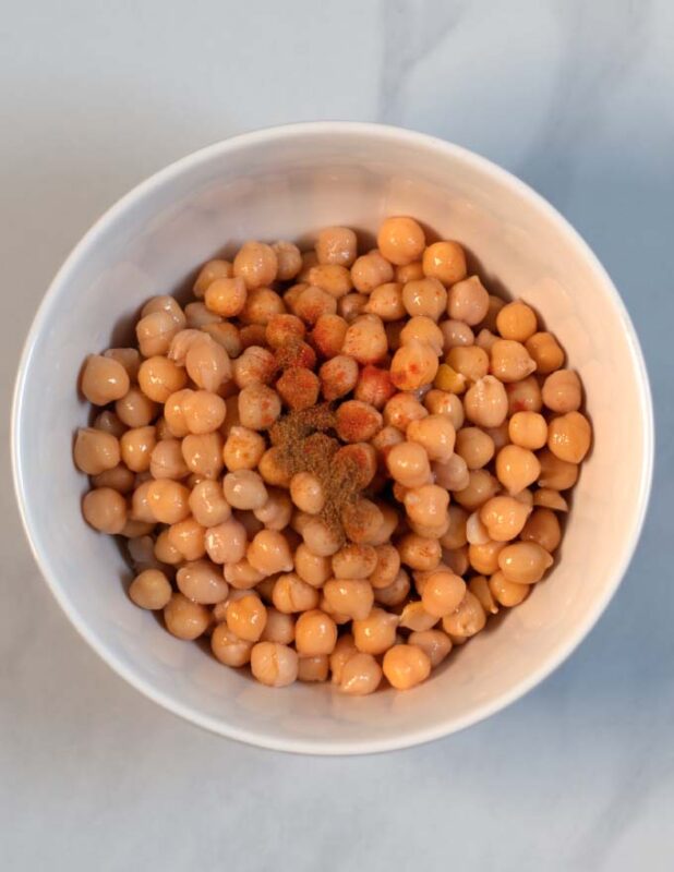 Chickpeas and spices are mixed.