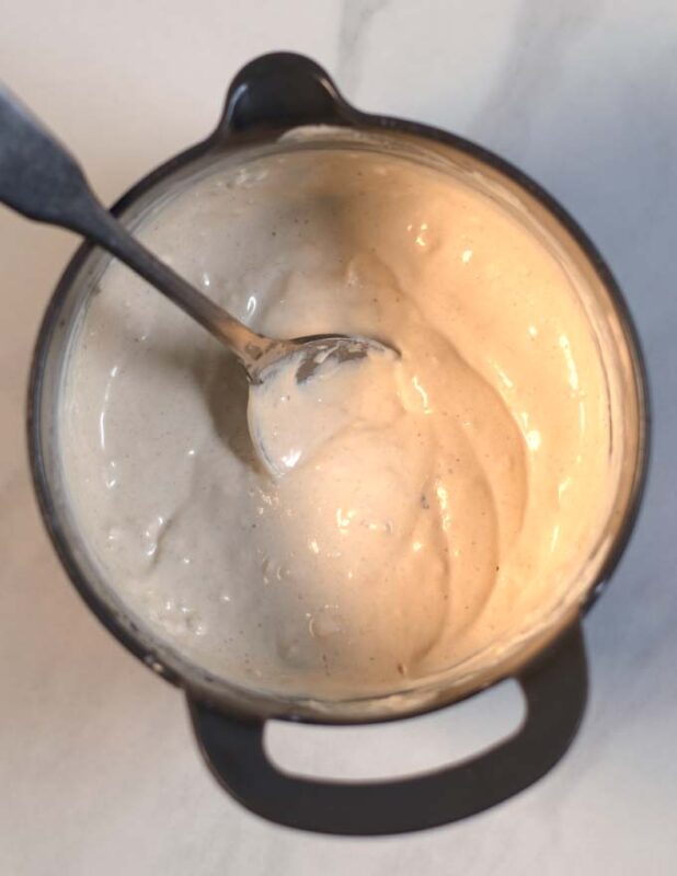 Ready yogurt sauce for Fatteh in a mixing bowl.