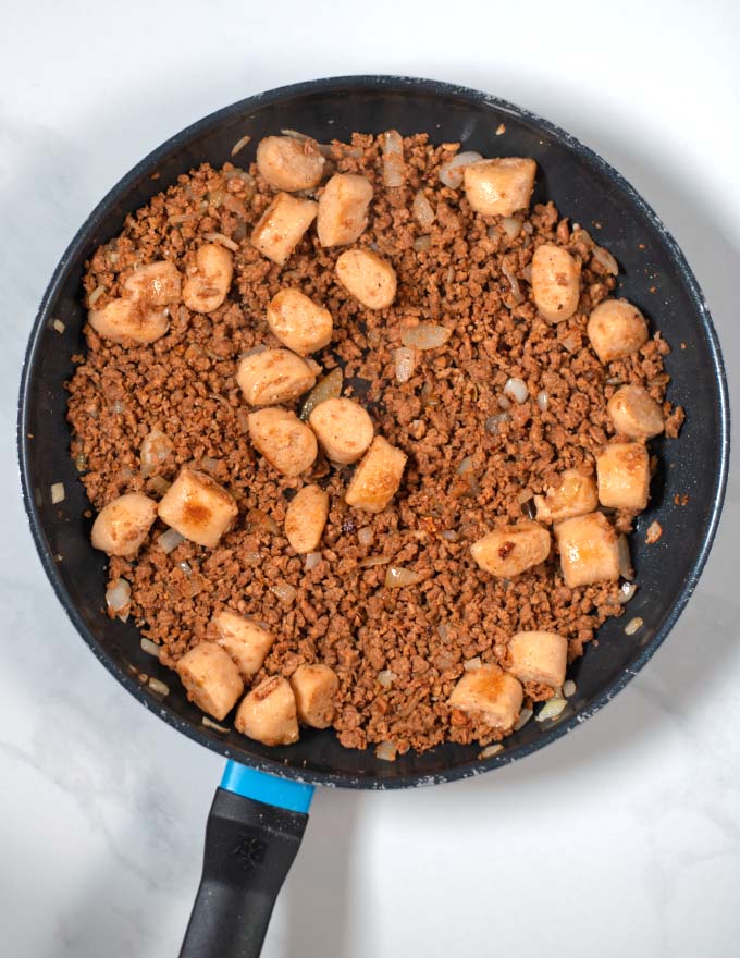 Vegan ground beef is added to the pan.