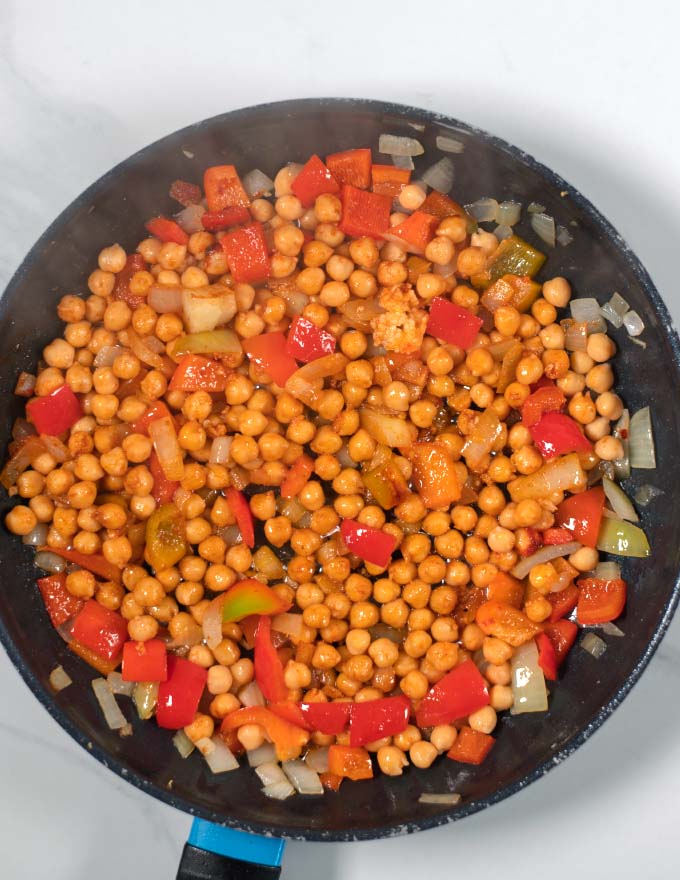 Spices are mixed with the ingreidents in the pan.