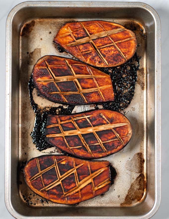 Baked and caramelized miso eggplant in a baking dish.